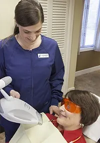 A hygienist at Hingham Dental Associates with a patient during ZOOM! whitening.