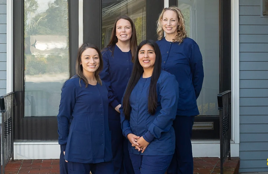 Members of the Hingham Dental Associates team at the front entrance.